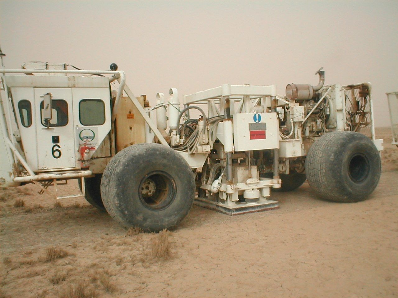 Vibroseis trucks lined up on a seismic line
